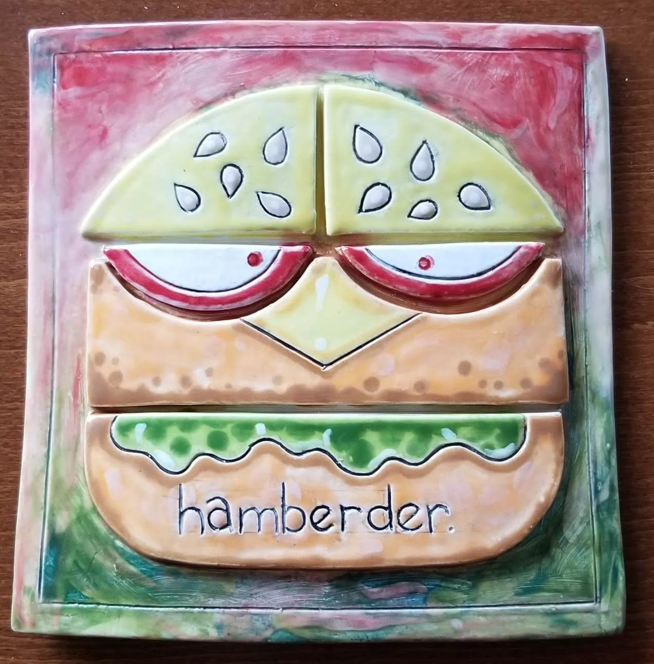 Handmade ceramic tile with hamburger design